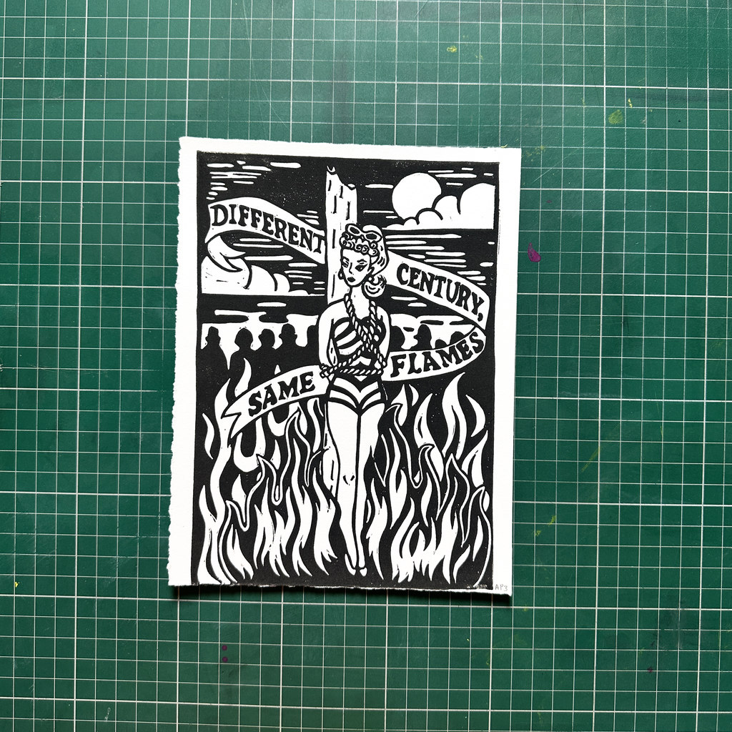 Black and white graphic design on a green cutting mat