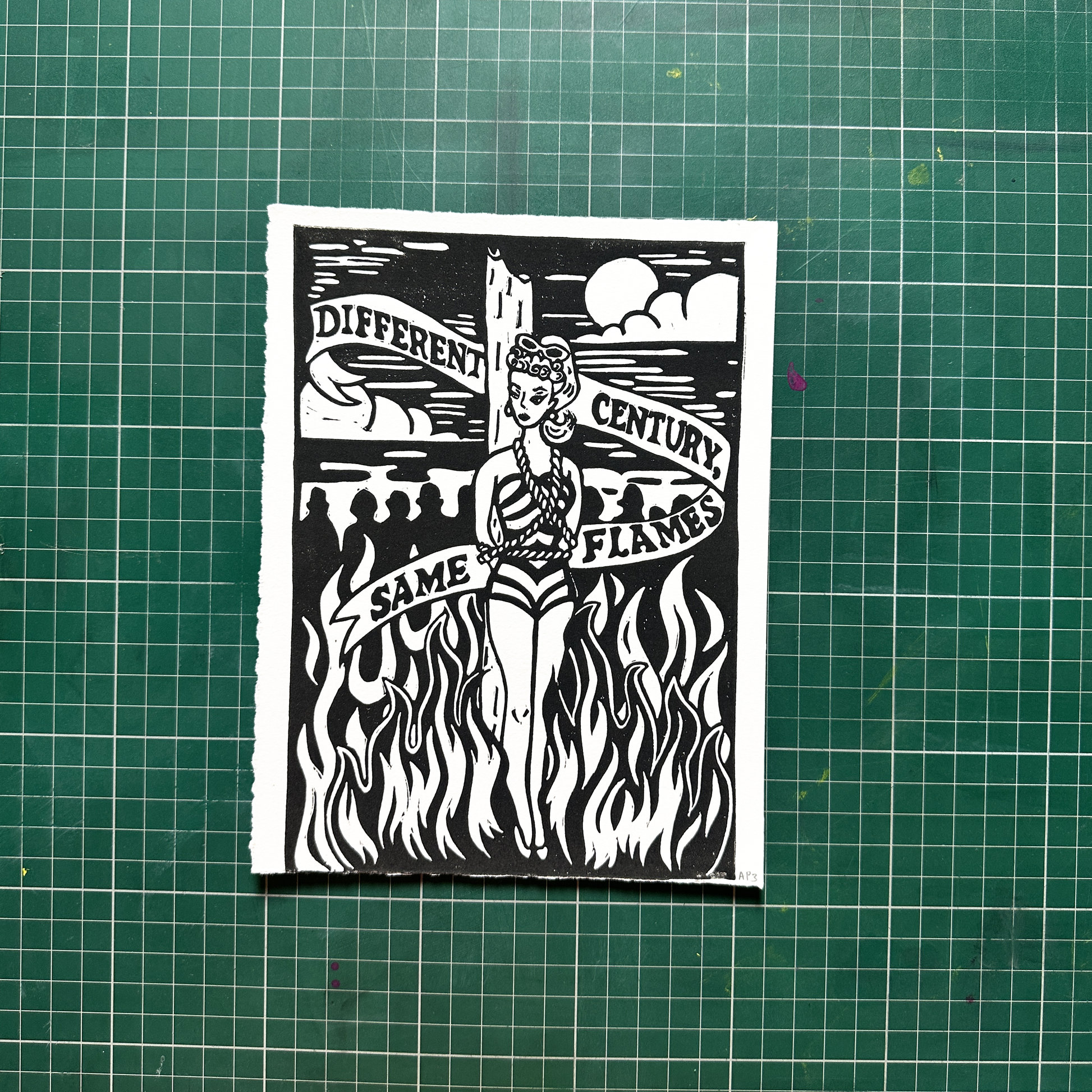 Black and white graphic design on a green cutting mat